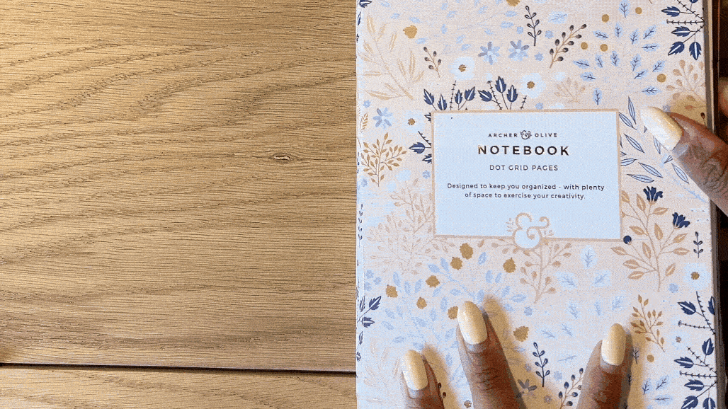 Gif of opening journal to a background with wrapping paper glued in